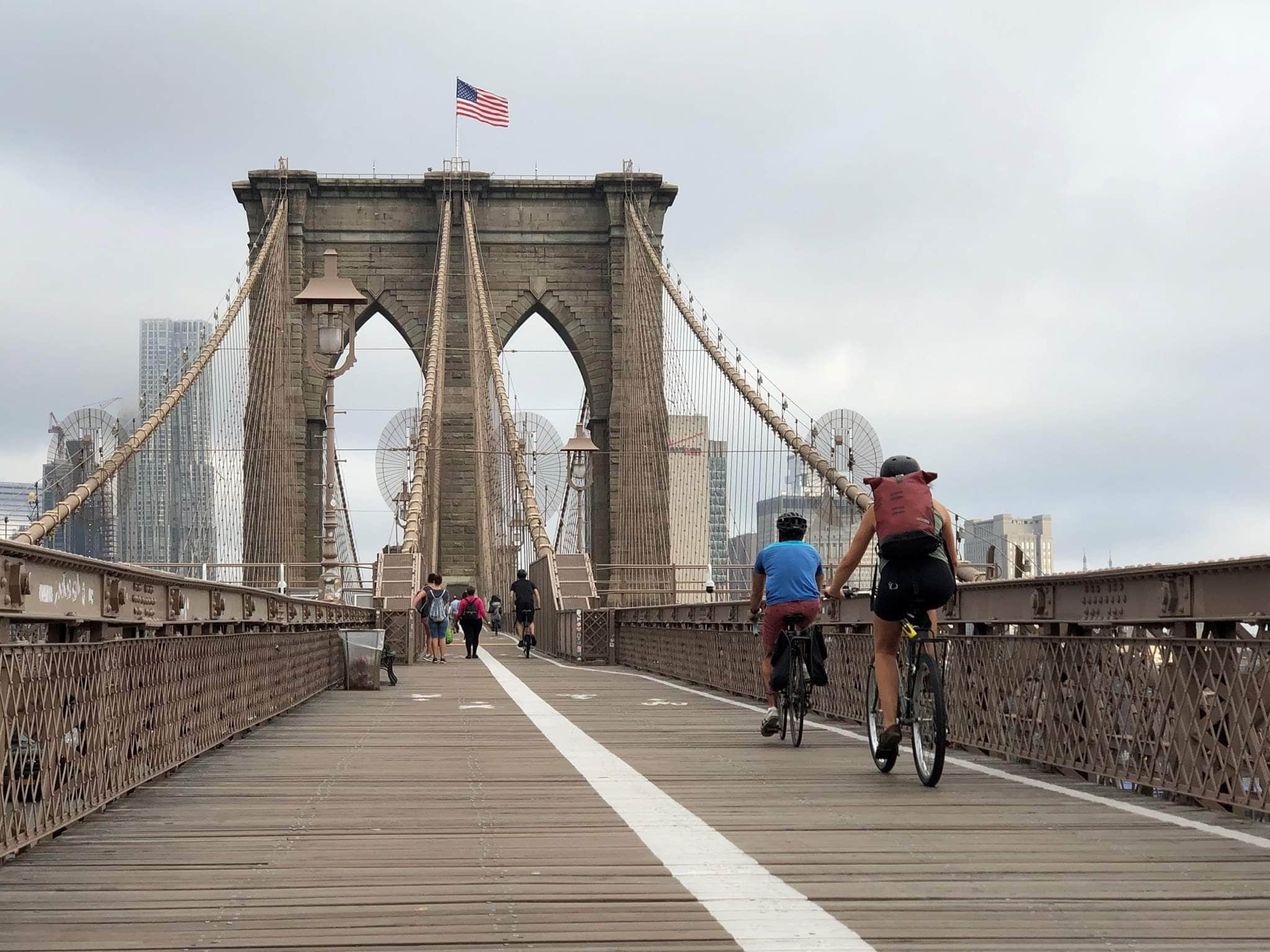 Pedestrians and riders crossing Brooklyn Bridge